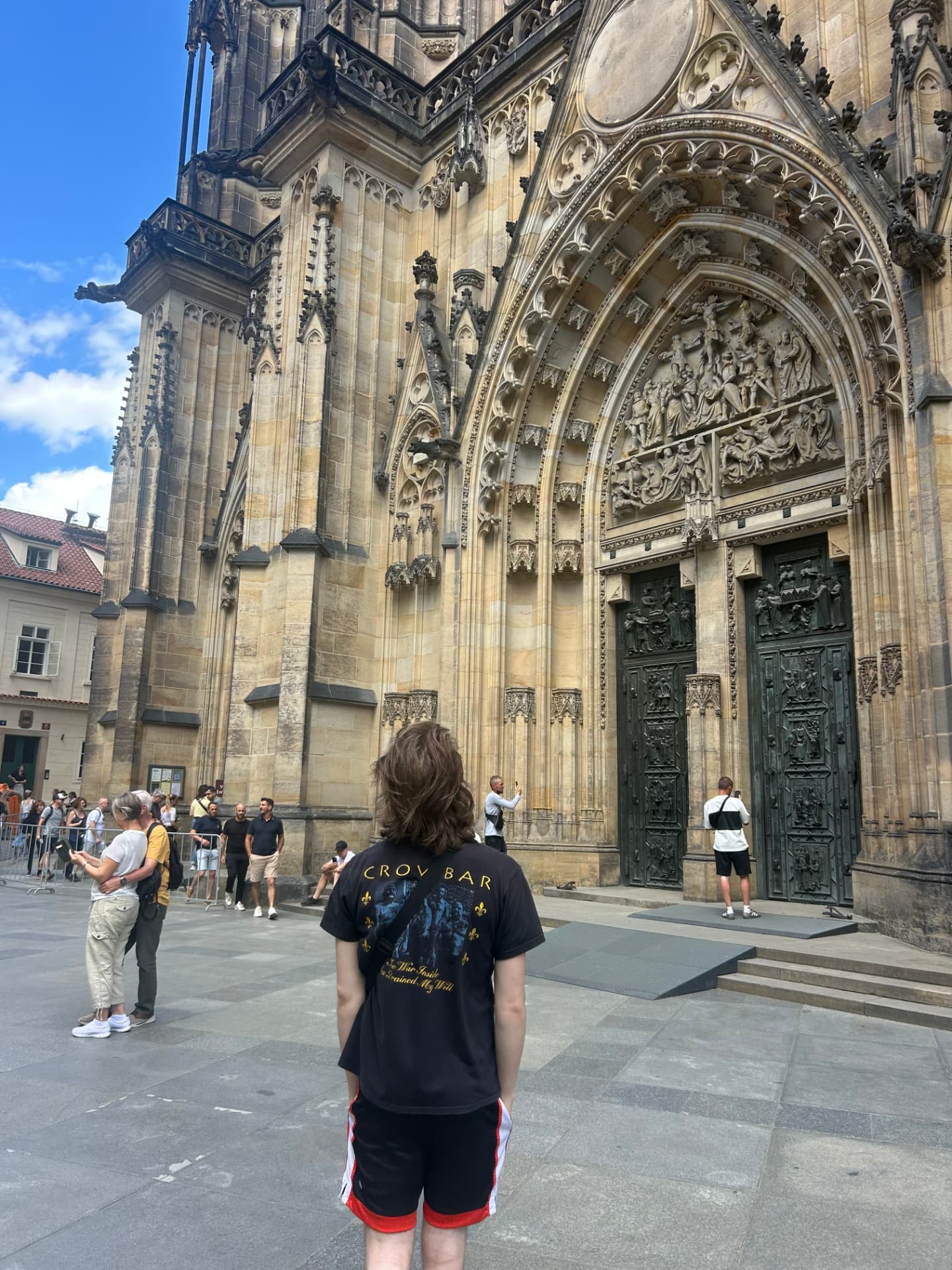 Backpacker looking up at St. Vitus Cathedral in Prague